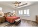 Inviting main bedroom featuring a tray ceiling, neutral decor, and ample natural light at 12685 W Montane Dr, Broomfield, CO 80021