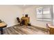 Bright office space with natural light, wood-look flooring, and a classic roll-top desk at 12685 W Montane Dr, Broomfield, CO 80021