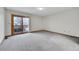Bedroom with light carpet, sliding glass doors with a balcony view of the outdoors at 13028 Garfield Dr, Thornton, CO 80241