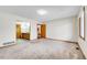 Bright bedroom featuring plush carpeting with views to ensuite and closet at 13028 Garfield Dr, Thornton, CO 80241