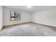 Spacious bedroom features neutral carpet and a window view of the outdoors at 13028 Garfield Dr, Thornton, CO 80241