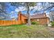 Charming brick home with well-kept lawn and wooden fence, creating a cozy curb appeal at 13028 Garfield Dr, Thornton, CO 80241