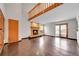Bright living room with fireplace, wooden floors and doors that lead to the backyard at 13028 Garfield Dr, Thornton, CO 80241