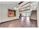 Bright living room features hardwood floors, fireplace, vaulted ceilings, and open staircase at 13028 Garfield Dr, Thornton, CO 80241