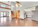 Open living space showcasing hardwood floors, stairs, and views to the kitchen and backyard at 13028 Garfield Dr, Thornton, CO 80241