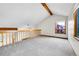Loft area with vaulted ceilings, neutral carpet, and a bright window view at 13028 Garfield Dr, Thornton, CO 80241