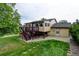 Exterior of home featuring a wooden deck and a spacious backyard with green grass and a shed at 9766 Fillmore St, Thornton, CO 80229