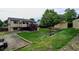 Spacious backyard with deck, mature trees, storage shed and gravel area at 9766 Fillmore St, Thornton, CO 80229