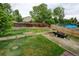 Expansive backyard featuring well-maintained grass, a wood fence, and a small utility trailer at 9766 Fillmore St, Thornton, CO 80229