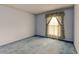 A bright bedroom featuring blue carpet and a window with light-filtering curtains at 9766 Fillmore St, Thornton, CO 80229