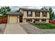 Charming two-story home featuring a manicured front lawn and attached one car garage at 9766 Fillmore St, Thornton, CO 80229