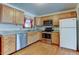 Efficient kitchen with stainless appliances, light wood cabinets, and easy-to-clean floors at 9766 Fillmore St, Thornton, CO 80229