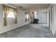 Spacious living room with blue carpeting, natural light, and stairway access to the upper level at 9766 Fillmore St, Thornton, CO 80229