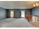 Spacious living room featuring neutral carpet, wallpaper, and plenty of natural light at 9766 Fillmore St, Thornton, CO 80229
