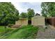 Backyard featuring a shed with a brick path and a small garden area with mature vegetation at 9766 Fillmore St, Thornton, CO 80229