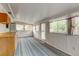 Bright sun room with several windows, light wood cabinetry, and unique patterned flooring at 9766 Fillmore St, Thornton, CO 80229