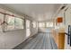 Bright sun room with several windows, light wood cabinetry, and unique patterned flooring at 9766 Fillmore St, Thornton, CO 80229