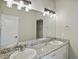 Bright bathroom features a double sink vanity with granite countertops and modern lighting fixtures at 4585 Mesa Top Dr, Monument, CO 80132