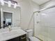 Well-lit bathroom with a glass enclosed shower, modern fixtures, and a dark vanity at 4585 Mesa Top Dr, Monument, CO 80132
