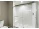 Clean bathroom showcasing a glass-enclosed shower with white tile and a built-in seat at 4585 Mesa Top Dr, Monument, CO 80132