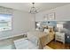 Inviting bedroom with hardwood floors, a decorative window, and modern lighting at 4585 Mesa Top Dr, Monument, CO 80132