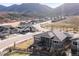 A wide-angle aerial showcasing the community nestled within the rolling, mountain-covered landscape at 4585 Mesa Top Dr, Monument, CO 80132