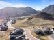 This aerial view shows homes in a beautiful community surrounded by hilly, open space at 4585 Mesa Top Dr, Monument, CO 80132