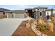 Stunning single-Gathering home with stone accents, three-car garage, and beautifully landscaped front yard at 4585 Mesa Top Dr, Monument, CO 80132
