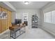 Spacious home office featuring a desk, wood accent wall, and natural light at 4585 Mesa Top Dr, Monument, CO 80132