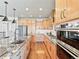 Bright kitchen boasts granite counters, stainless appliances, modern cabinetry, and hardwood flooring at 4585 Mesa Top Dr, Monument, CO 80132
