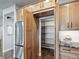 Well-equipped kitchen with stainless steel refrigerator, cabinets, and walk-in pantry at 4585 Mesa Top Dr, Monument, CO 80132