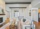 Spacious open-concept living room with fireplace, hardwood floors, and modern furnishings at 4585 Mesa Top Dr, Monument, CO 80132