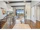 Bright living room with hardwood floors, fireplace, stone accent wall, and exposed ceiling beams at 4585 Mesa Top Dr, Monument, CO 80132