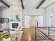 Bright living room with fireplace, TV, and sliding barn doors leading to other rooms at 4585 Mesa Top Dr, Monument, CO 80132