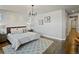 The main bedroom shows textured accent wall, stylish light fixture, and new wood flooring at 4585 Mesa Top Dr, Monument, CO 80132