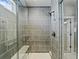 Modern tiled shower featuring a built-in bench, matte fixtures, and glass doors at 4585 Mesa Top Dr, Monument, CO 80132