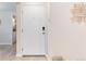 Inviting entryway featuring a secure door, neutral walls with elegant art, and a glimpse of the laundry area at 12172 Melody Dr # 102, Denver, CO 80234