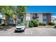 Charming condo building featuring balconies, lush greenery, designated parking, and a welcoming entrance at 12172 Melody Dr # 102, Denver, CO 80234