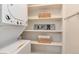 Laundry area with washer/dryer unit and built-in storage shelves at 12172 Melody Dr # 102, Denver, CO 80234
