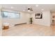 Bright living room showcasing a ceiling fan, large window, modern décor, and light wood-look floors at 12172 Melody Dr # 102, Denver, CO 80234
