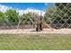 View of outdoor playground featuring a swing set, slide, and climbing structure inside a fenced in area at 12172 Melody Dr # 102, Denver, CO 80234