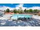 View of outdoor swimming pool with various trees, and lounge chairs at 12172 Melody Dr # 102, Denver, CO 80234