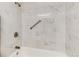 Bright shower featuring white marble tiling and silver fixtures at 12172 Melody Dr # 102, Denver, CO 80234