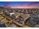 Expansive neighborhood aerial view featuring a colorful sunset, showcasing the community layout and home exteriors at 6817 Sequoia St, Frederick, CO 80530