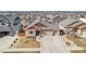 Aerial view of home with a large driveway and professional landscaping nestled in a quiet neighborhood at 6817 Sequoia St, Frederick, CO 80530