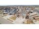 An aerial view of the home and neighborhood, with a lush green lawn and mature trees at 6817 Sequoia St, Frederick, CO 80530