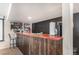 Basement bar area with wooden counter, bar stools, and stylish decor, perfect for entertaining at 6817 Sequoia St, Frederick, CO 80530