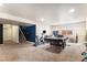 Finished basement area with carpet, stairs, exercise bike, pool table, and plenty of space at 6817 Sequoia St, Frederick, CO 80530