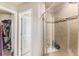 The bathroom includes a glass shower, a walk-in closet, and neutral colored tile at 6817 Sequoia St, Frederick, CO 80530