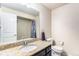 The bathroom features a tiled shower, a granite countertop, a large vanity mirror, and a single sink at 6817 Sequoia St, Frederick, CO 80530